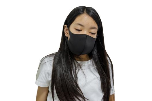 An Asian long haired girl wearing a black mask is ill with the flu. On a white background.Clipping path
