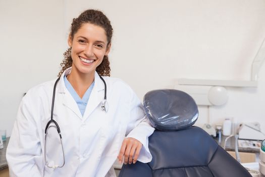 Confident dentist smiling at the camera at the dental clinic