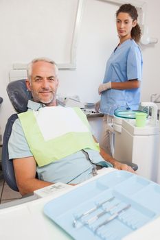 Patient smiling at camera sitting in the chair at the dental clinic