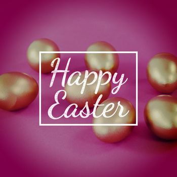 happy easter against golden easter eggs on pink background