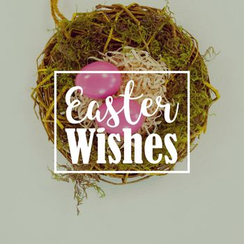 Easter greeting against pink easter eggs in the nest