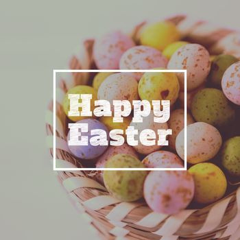 happy easter against colorful easter eggs in wicker basket