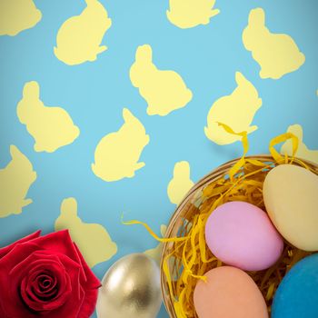 Picture of a rose against colorful easter eggs in wicker basket nest