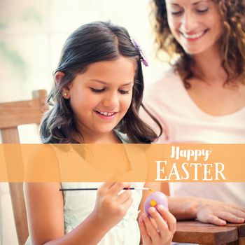 Happy mother and daughter painting easter eggs  against easter greeting