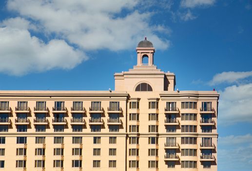 A hotel with classic architecture against a clear blue sky