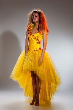 Young woman in a weddng dress on a studio background