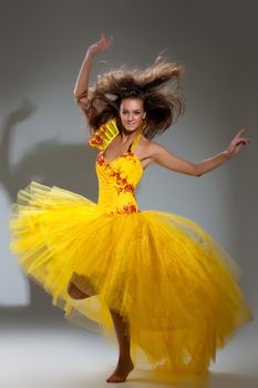 Young beautiful woman in a wedding dress on a studio background