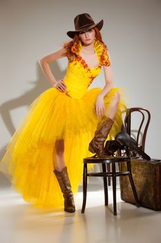 Young beautiful woman in a wedding dress on a studio background