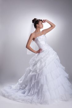 Young beautiful dark-haired woman in a wedding fashionable dress