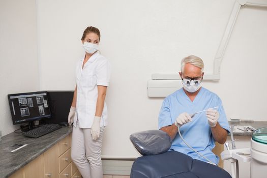 Dentist and assistant getting ready for patient at the dental clinic
