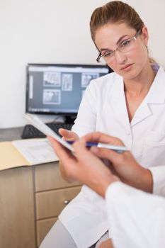 Dentist and assistant studying x-rays on computer at the dental clinic