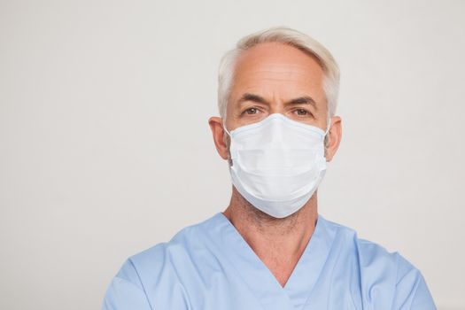 Dentist in surgical mask looking at camera at the dental clinic