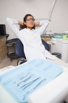 Dentist sitting back and relaxing at the dental clinic