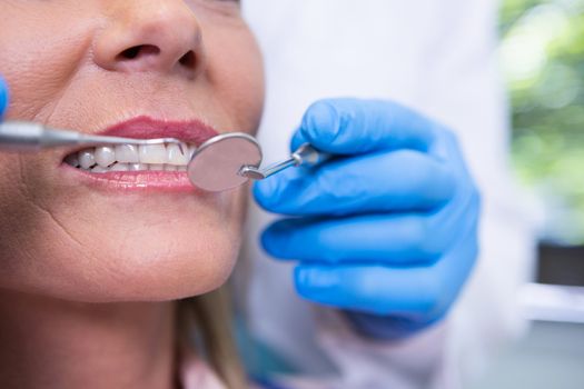 Close up of dentist examining woman at medical clinic