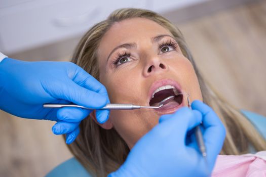 Close up of dentist examining woman at hospital