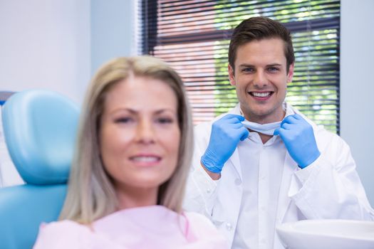 Portrait of happy patient and dentist  at dental clinic