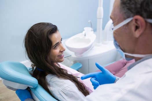 Dentist talking with patient at medical clinic