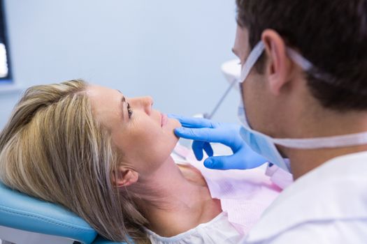 Close up of dentist examining woman at medical clinic