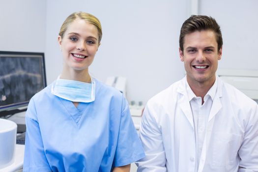 Portrait of happy nurse and dentist in clinic
