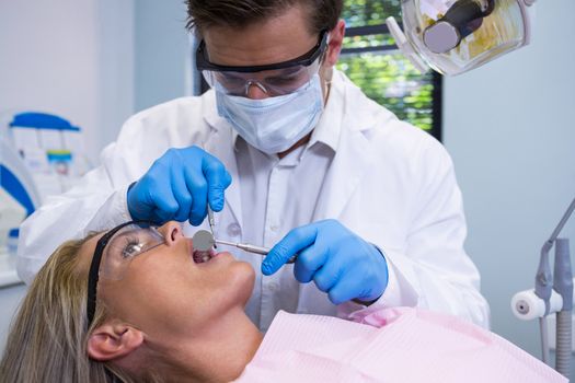 Close up of dentist examining woman at clinic