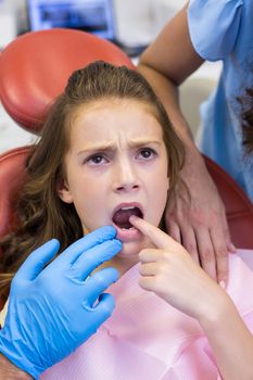 Dentist examining young patient at dental clinic