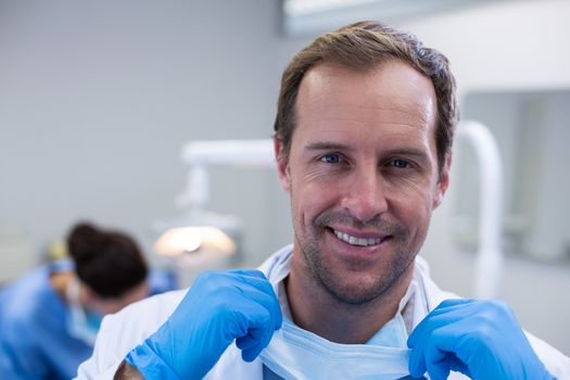 Portrait of smiling dentist in dental clinic