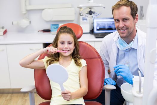 Portrait of smiling young patient with a dentist in dental clinic