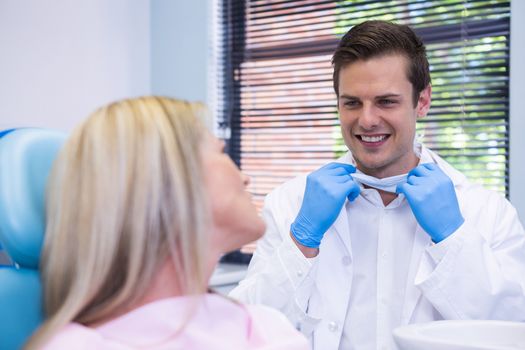 Happy patient talking with dentist at clinic