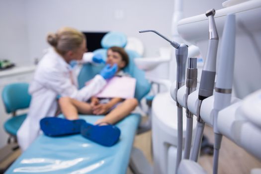 Close up of medical equipment by dentist examining boy at medical clinic