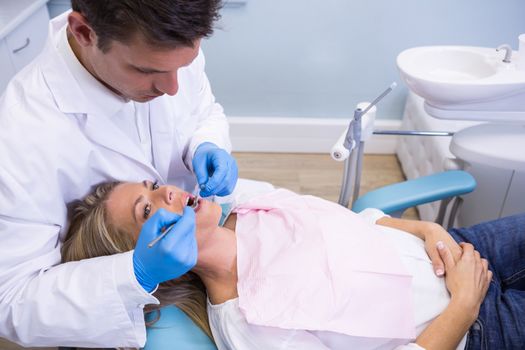 High angle view of dentist examining patient at clinic