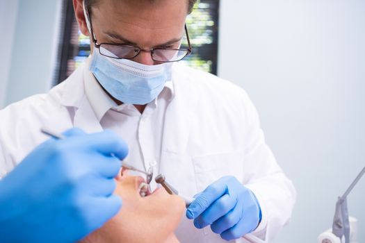 Close up of dentist examining patient in medical clinic