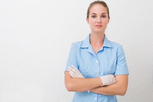 Serious dental assistant looking at camera at the dental clinic