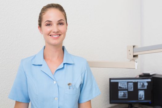 Smiling dental assistant looking at camera at the dental clinic