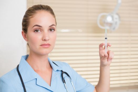 Dental assistant preparing an injection at the dental clinic