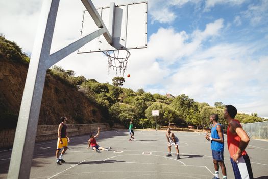 Basketball player taking a penalty shot in basketball court outdoors