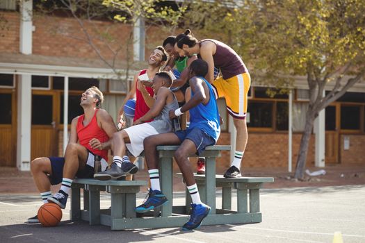 Basketball players taking a selfie in basketball court outdoors