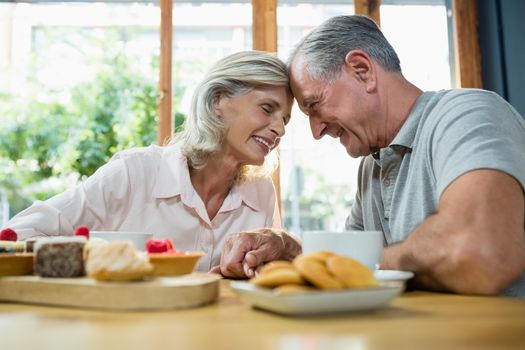 Romantic senior couple sitting together in cafÃ©