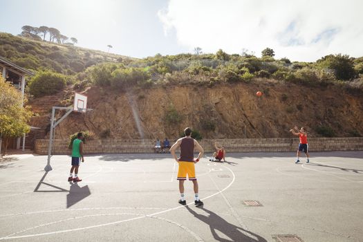 Basketball player taking a penalty shot in basketball court outdoors