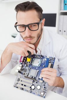 Computer engineer working on broken cpu in his office