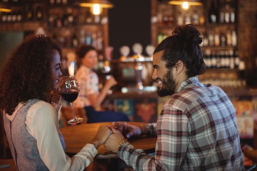 Romantic couple having red wine in pub