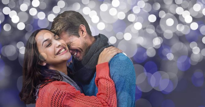 Digital composite of Romantic man embracing woman over blur background