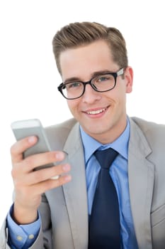 Nerdy businessman sending a text on white background