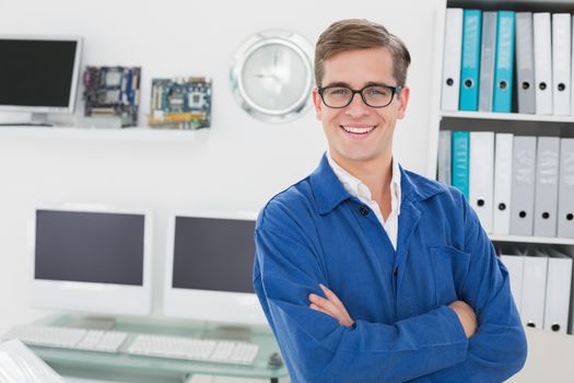Smiling technician looking at camera in his office
