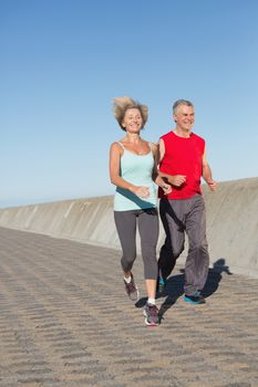 Active senior couple out for a jog on a sunny day