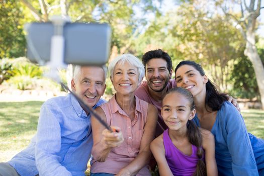 Smiling family taking a selfie in the park