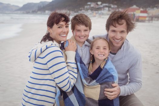 Portrait of family smiling together at beach