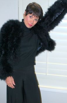 Mature female beauty expressions wearing a black outfit indoors.