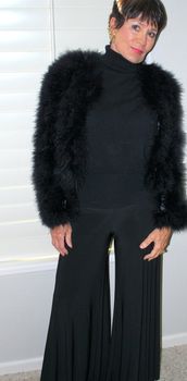 Mature female beauty expressions wearing a black outfit indoors.