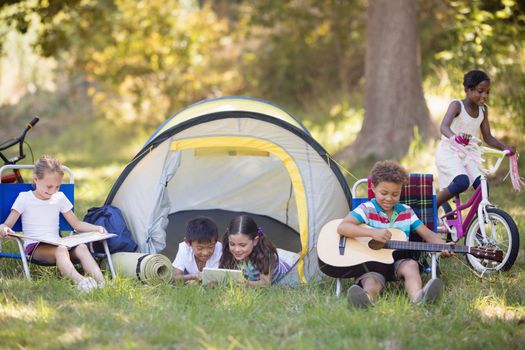 Children enjoying at campsite during summer vacations