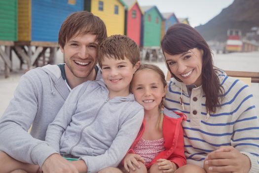 Portrait of happy family sitting at beach